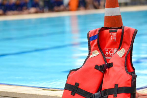 Life jacket placed infront of a pool. 