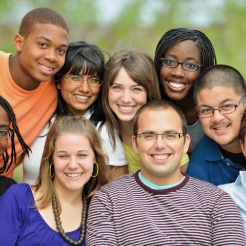 A diverse group of teens, smiling for the camera